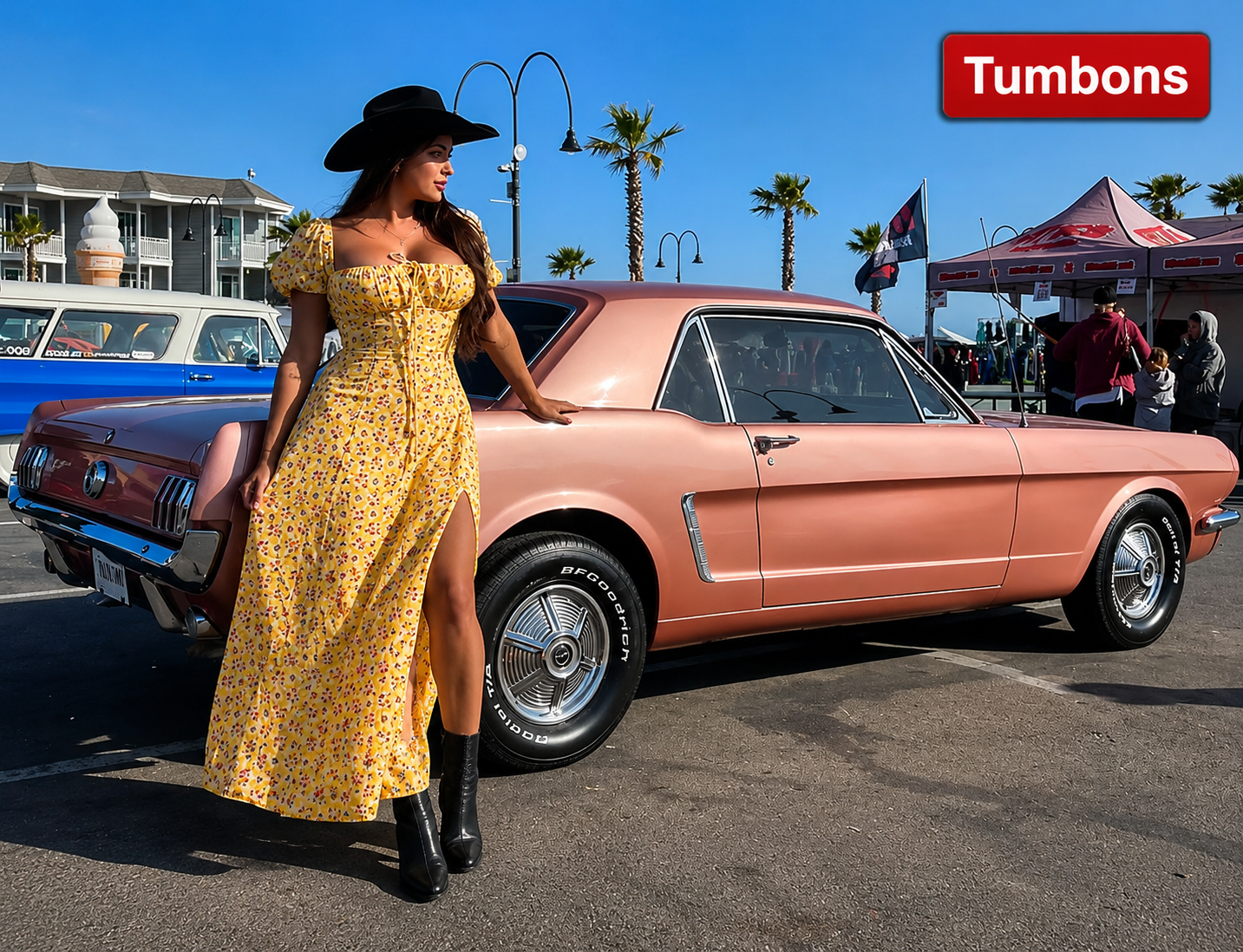 Constance Nunes standing with a restored classic Mustang linked to her car building and restoration career.
