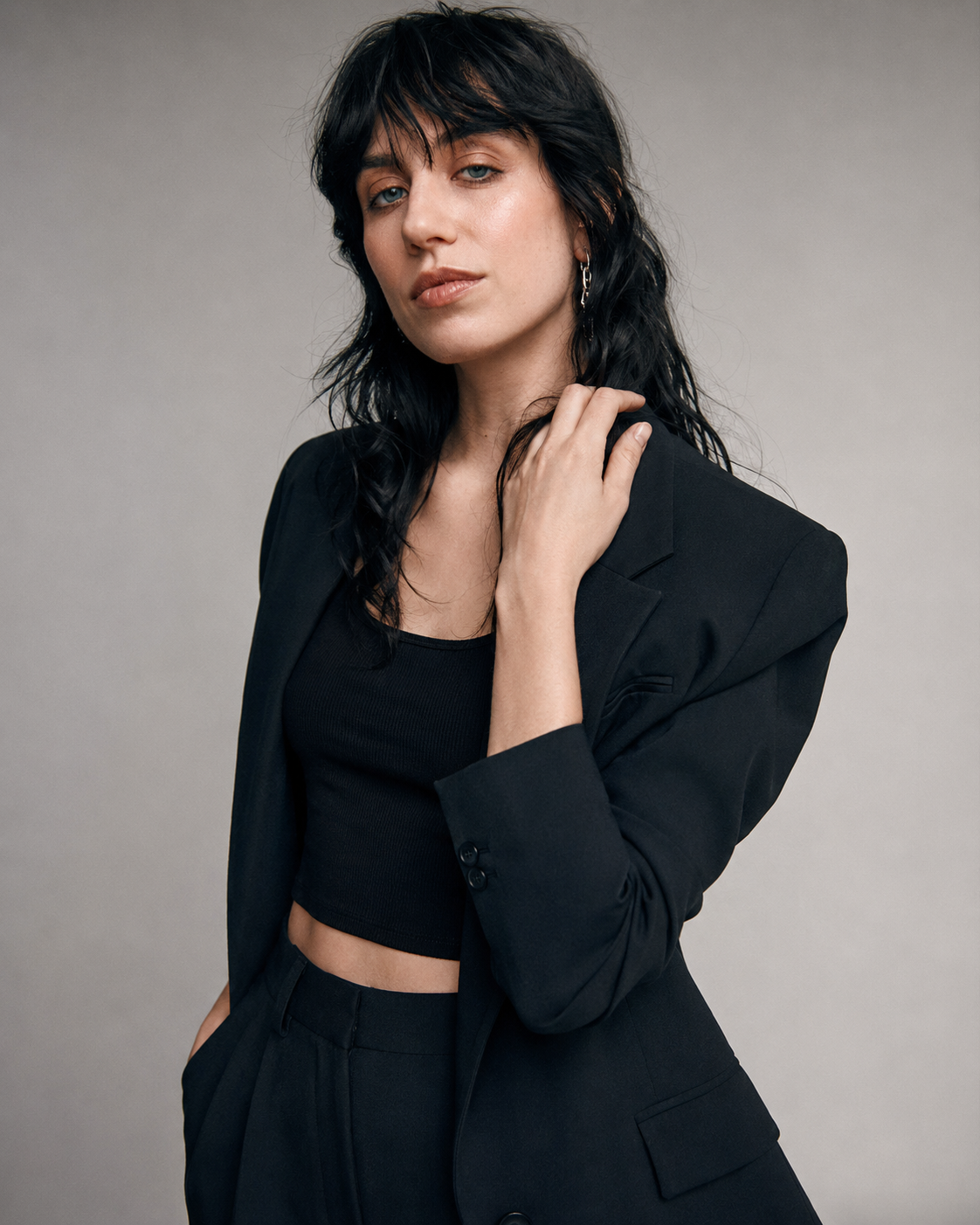 Editorial portrait of a woman in black fashion outfit for a Harriet Cains profile article.